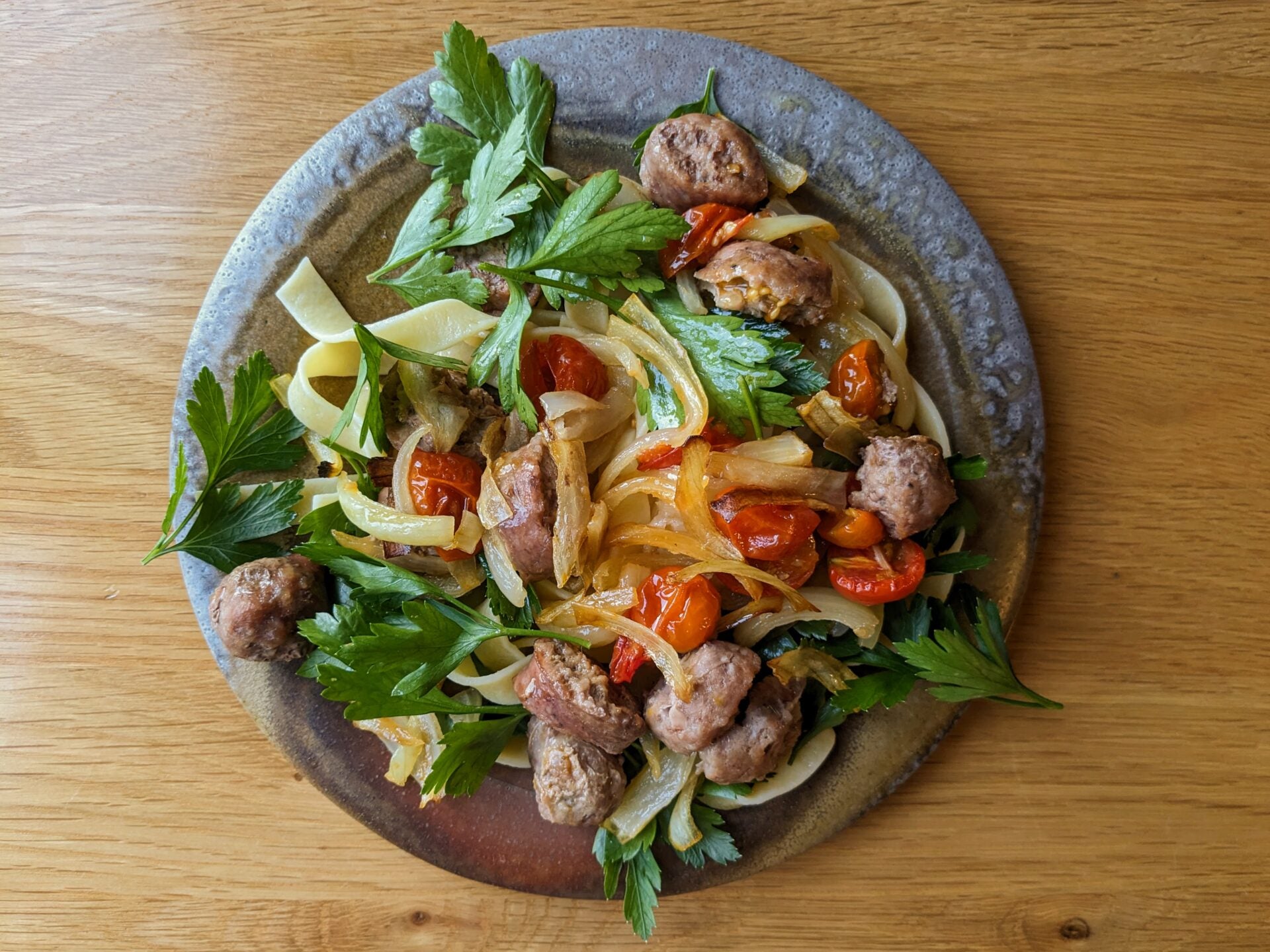 Linguine with tomato, sausage, and herbs.