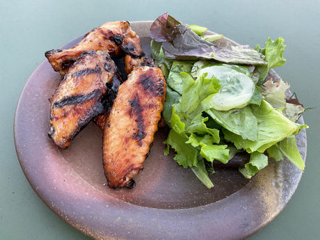 Grilled miso chicken wings with a side of salad